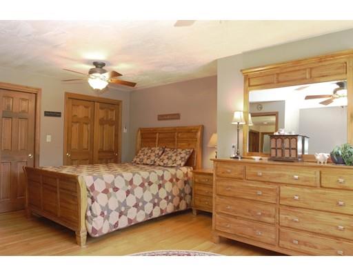 28 McGuire Road Sutton, MA 01590 - Photo 20 of 30 a bedroom with a large bed and a chandelier