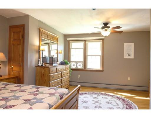 28 McGuire Road Sutton, MA 01590 - Photo 22 of 30 a bedroom with a bed and wooden floor