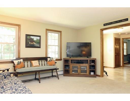 28 McGuire Road Sutton, MA 01590 - Photo 3 of 30 a living room with furniture and a flat screen tv