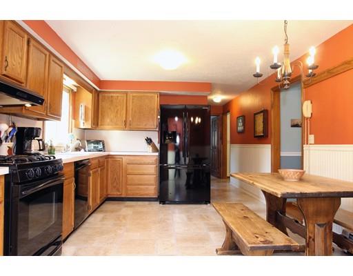 28 McGuire Road Sutton, MA 01590 - Photo 10 of 30 a kitchen with a stove a refrigerator and wooden cabinets