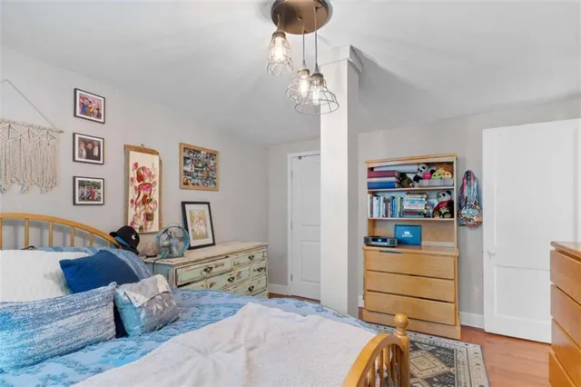 a bedroom with furniture and a wooden floor