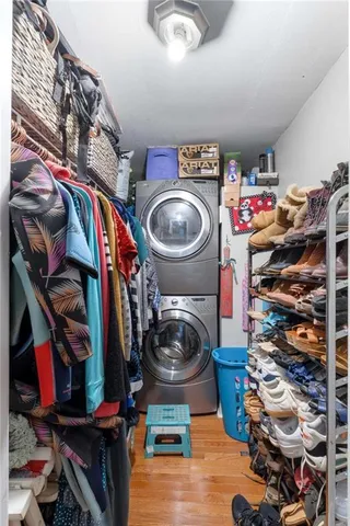 a view of walk in closet with clothes and shoes