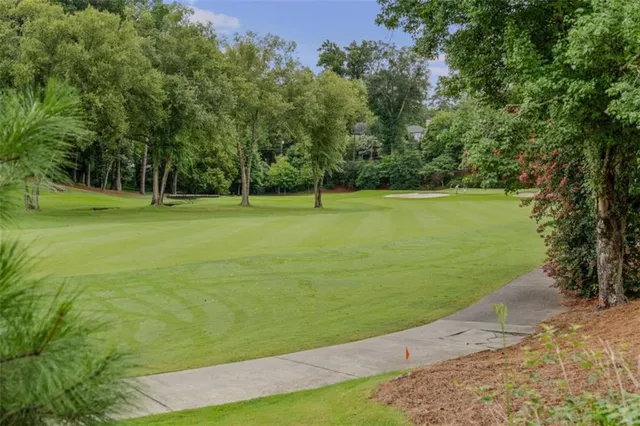 a view of a golf course with a large trees