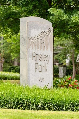 a view of a sign board with tall buildings