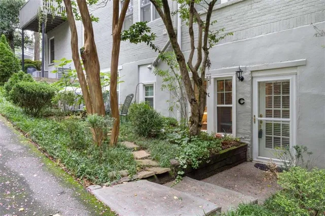 a front view of a house with a garden