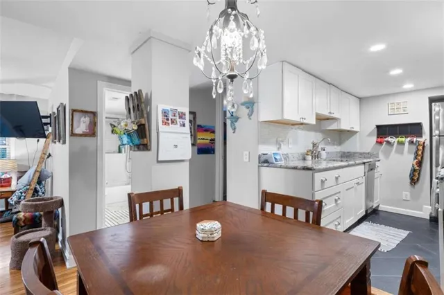 a kitchen with stainless steel appliances granite countertop a stove refrigerator and cabinets