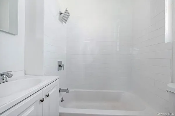 a bathroom with a bathtub and shower