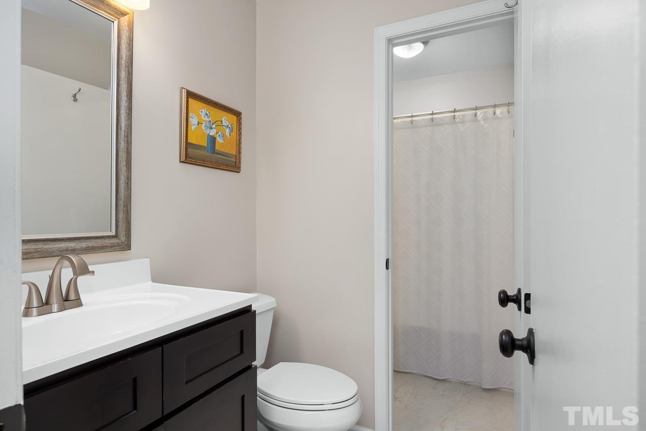 7724 Cart Track Trail Raleigh, NC 27615 - Photo 12 of 28 a bathroom with a sink vanity mirror and toilet