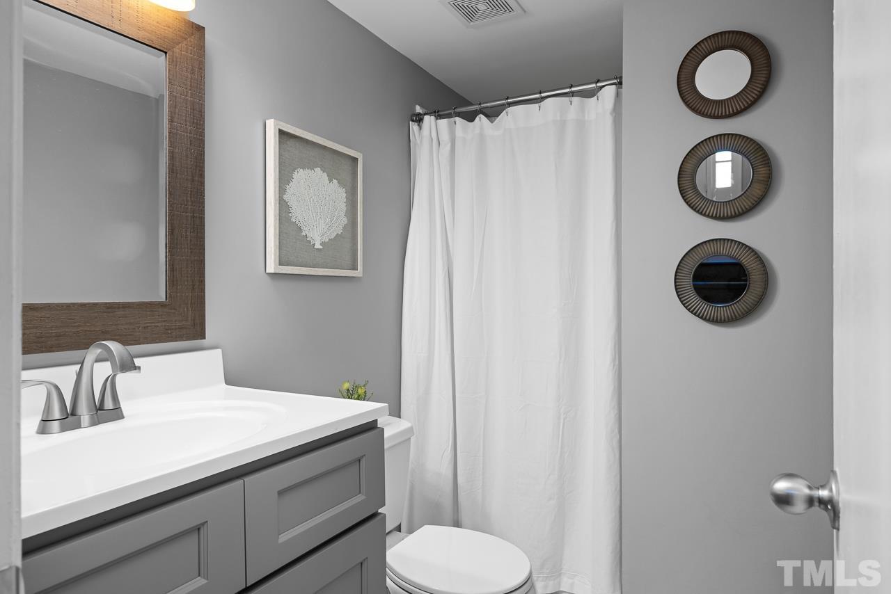 7724 Cart Track Trail Raleigh, NC 27615 - Photo 18 of 28 a bathroom with a sink and a mirror