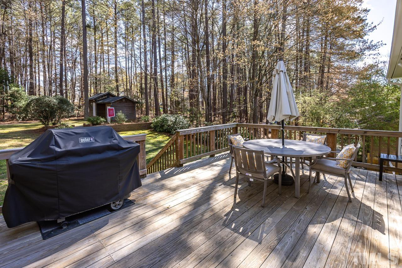 7724 Cart Track Trail Raleigh, NC 27615 - Photo 20 of 28 a view of a patio with table and chairs with wooden floor and fence