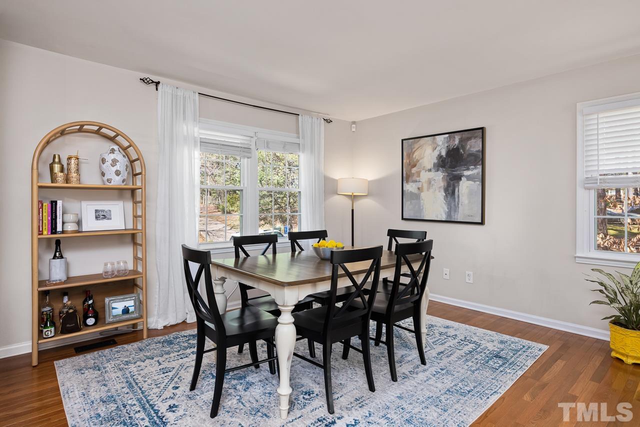 7724 Cart Track Trail Raleigh, NC 27615 - Photo 4 of 28 a view of a dining room with furniture window and wooden floor