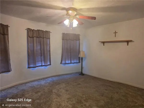 a view of a livingroom with an empty space and a window