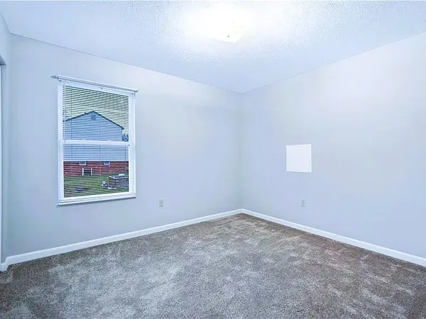 a view of an empty room with a fireplace