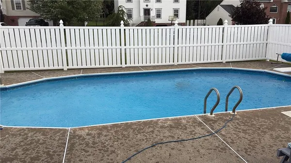 an empty room with a window and a ceiling fan