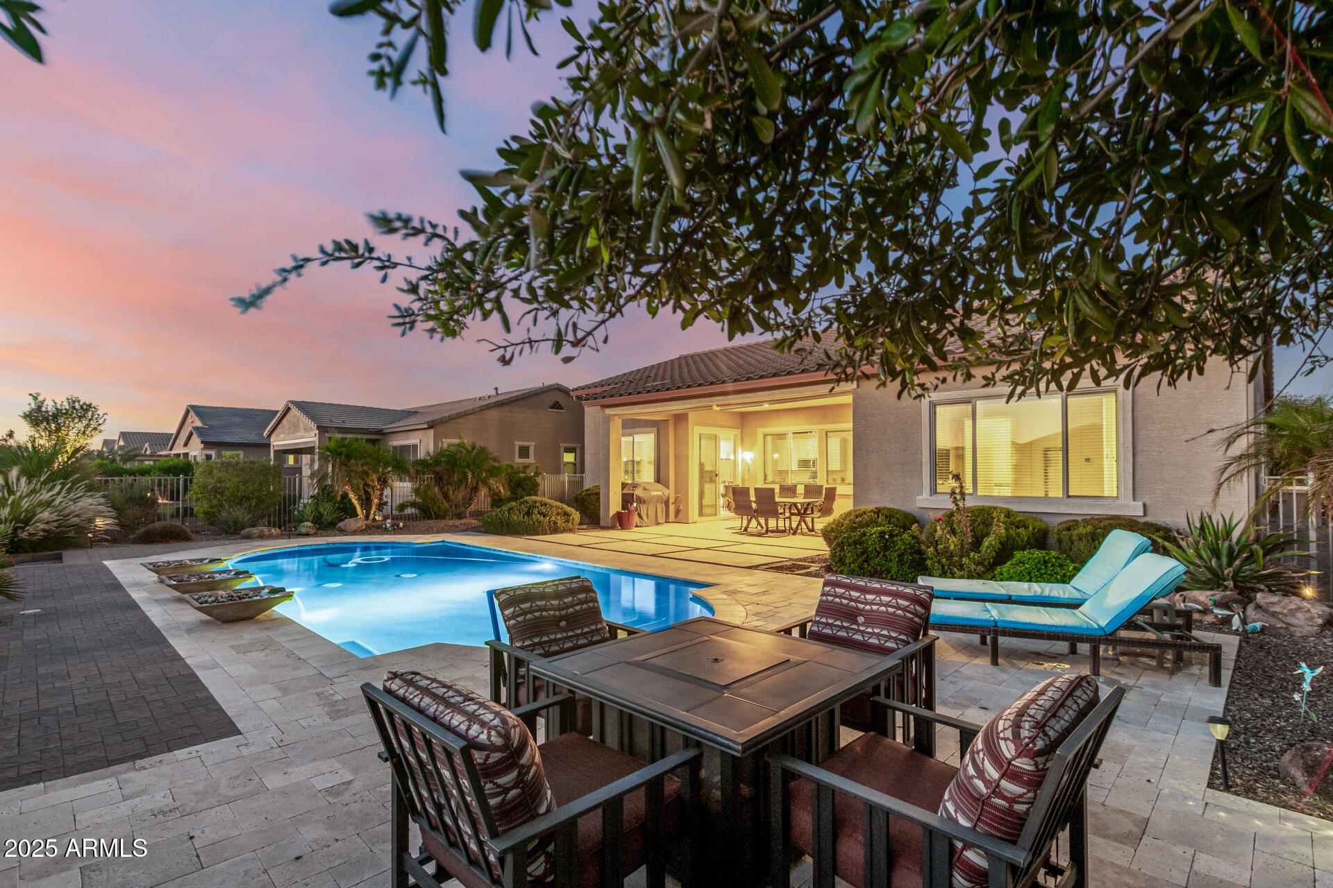 a view of a house with swimming pool and sitting area