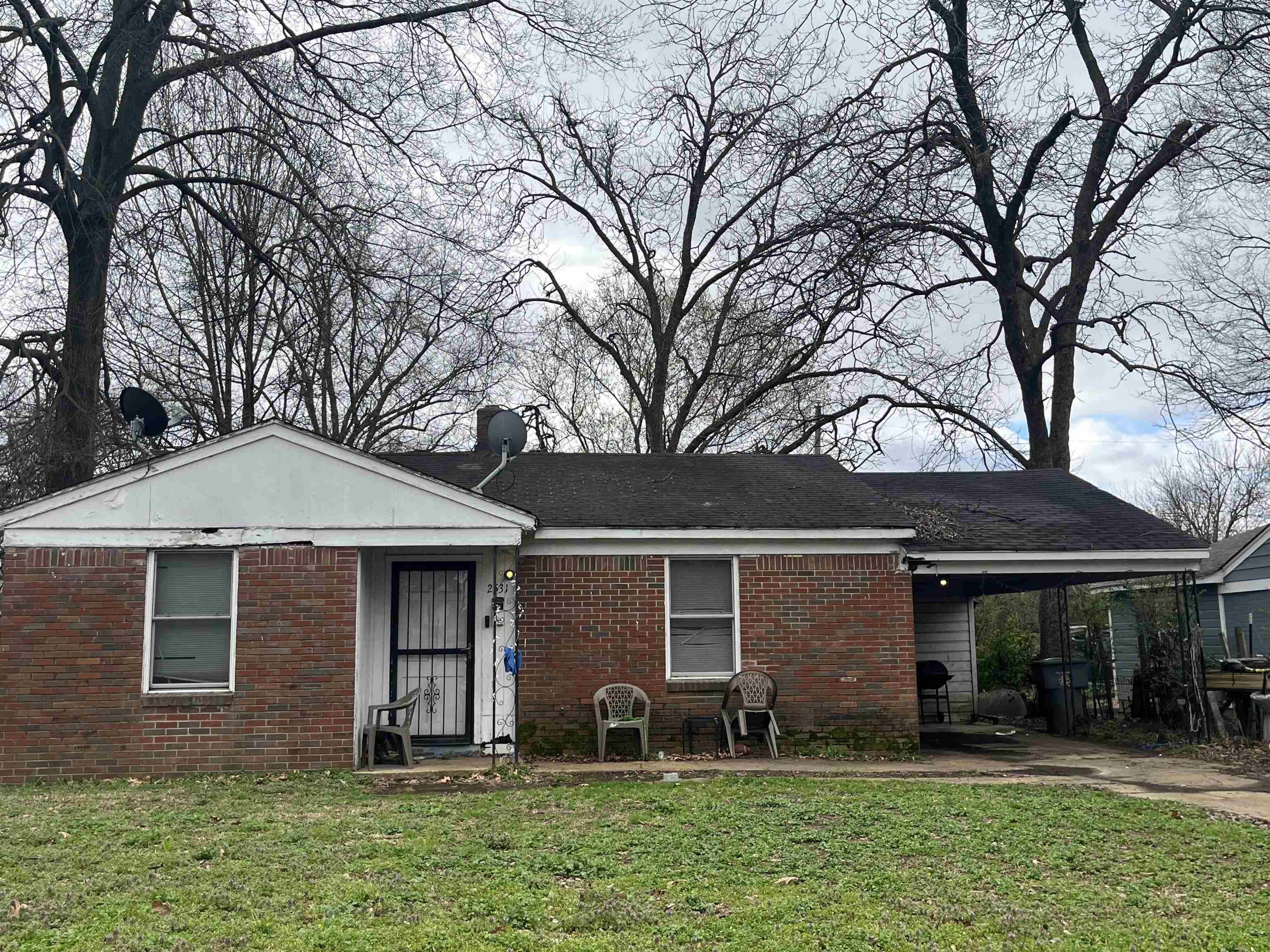 2531 Dwight Road Memphis, TN 38114 - Photo 3 of 3 View of front of house featuring a front yard, a carport, and brick siding