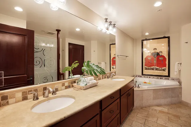 a bathroom with a sink double vanity granite and a mirror