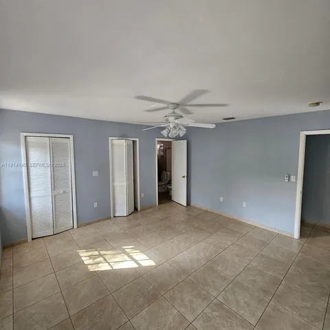 a view of a big room with windows and brick walls