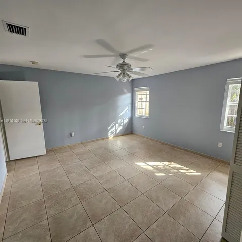 a view of a livingroom with a ceiling fan and window