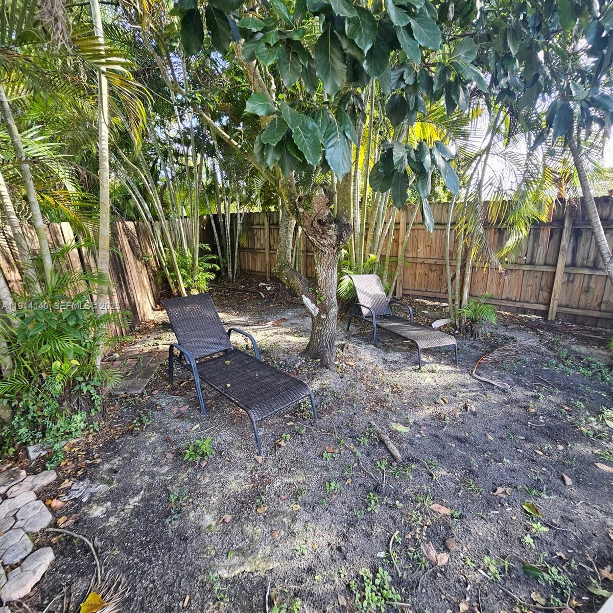 8330 Southwest 96th Place Miami, FL 33173 - Photo 28 of 28 a backyard of a house with lots of green space
