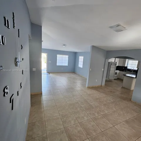 a view of a hallway view with wooden floor and staircase