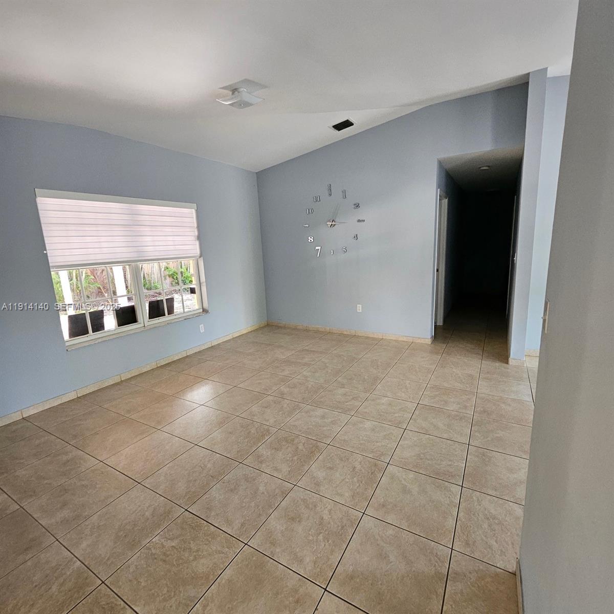 8330 Southwest 96th Place Miami, FL 33173 - Photo 5 of 28 a view of an empty room with a window