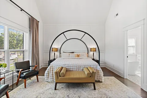 a bedroom with a bed and a large window
