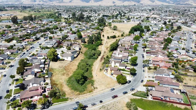 an aerial view of residential houses with outdoor space