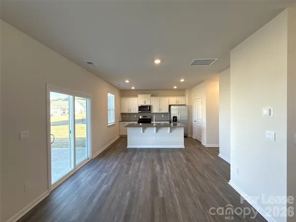 a view of a living room with furniture and wooden floor