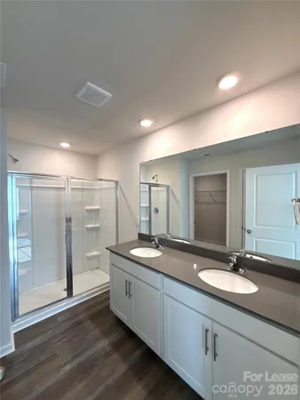 a bathroom with a double vanity sink and a mirror