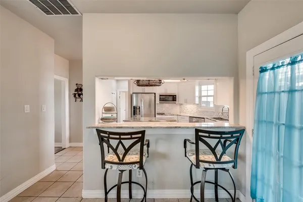 a kitchen with a table and chairs in it