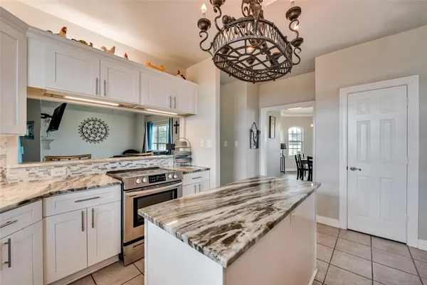 a kitchen with stainless steel appliances granite countertop a stove and cabinets