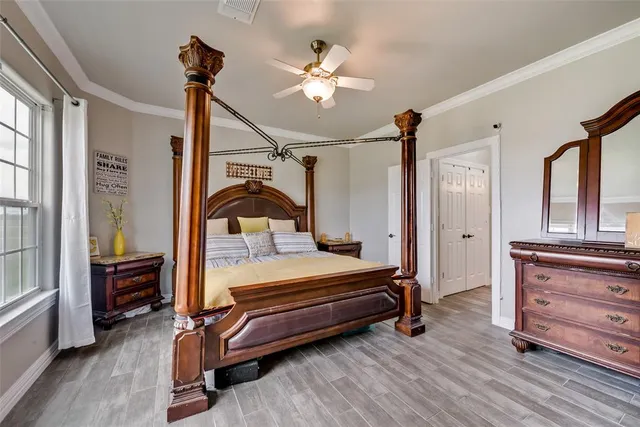 a bedroom with furniture and wooden floor