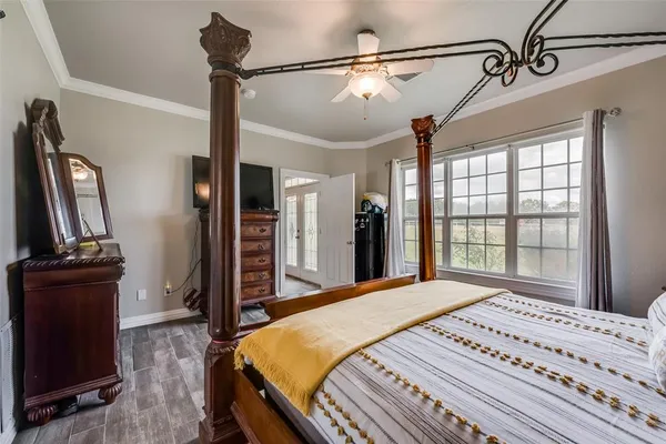 a bedroom with a bed window and dresser