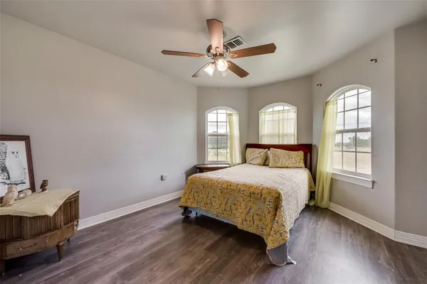 a bedroom with a bed window and couch