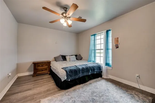 a spacious bedroom with a bed and a window