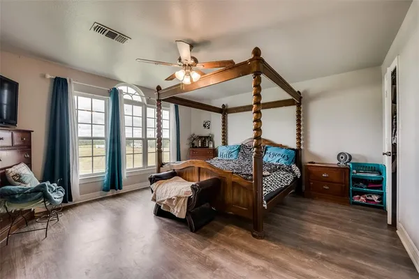 a bedroom with furniture and a window