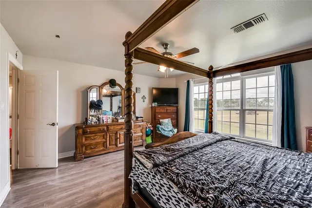 a living room with a large bed furniture and a large window