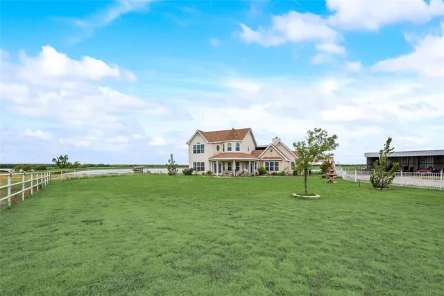 a view of a garden with a house in the background