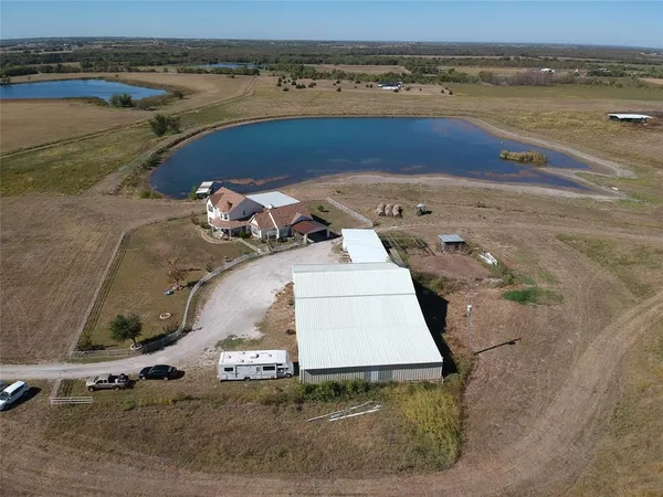 an aerial view of a house with a yard
