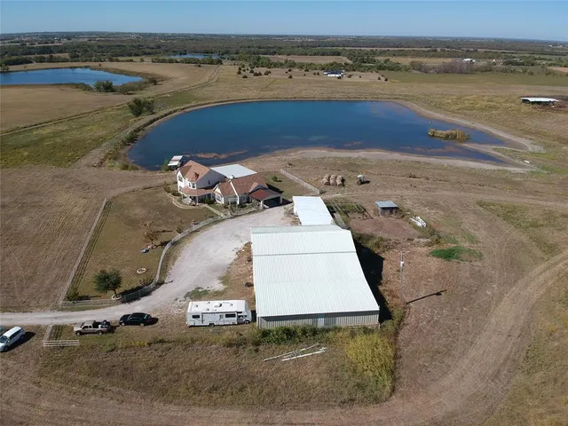 an aerial view of a house with a yard