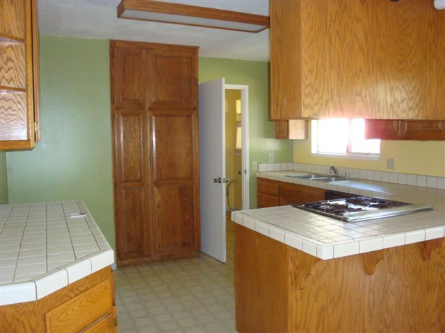 2707 Irwin Road Redding, CA 96002 - Photo 5 of 12 a kitchen with granite countertop a sink stove and cabinets
