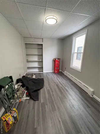 a room with gym equipment and a wooden floor