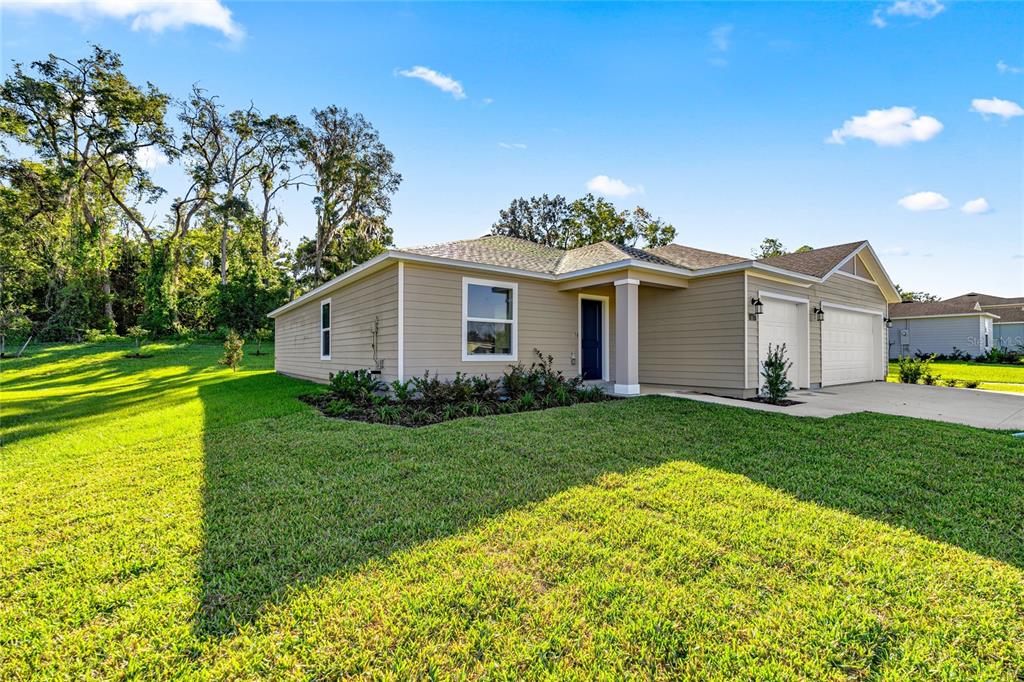 4597 Southwest 81st Loop Ocala, FL 34476 - Photo 2 of 6 a view of a house with backyard and garden
