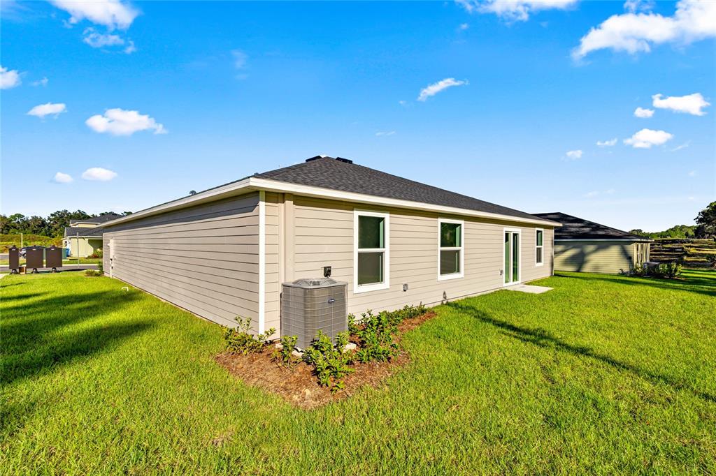 4597 Southwest 81st Loop Ocala, FL 34476 - Photo 3 of 6 a front view of a house with garden