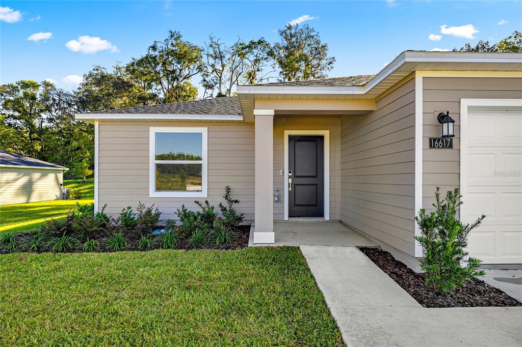 4597 Southwest 81st Loop Ocala, FL 34476 - Photo 4 of 6 a view of a house with a yard