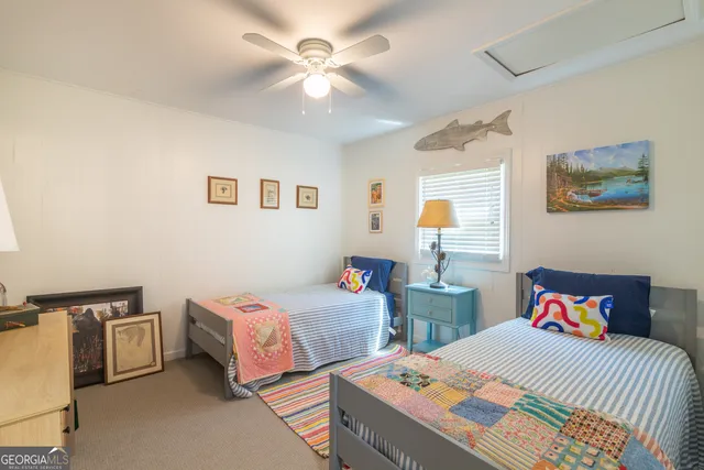 a bedroom with two beds and a chandelier