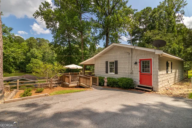 a view of backyard with outdoor seating and trees