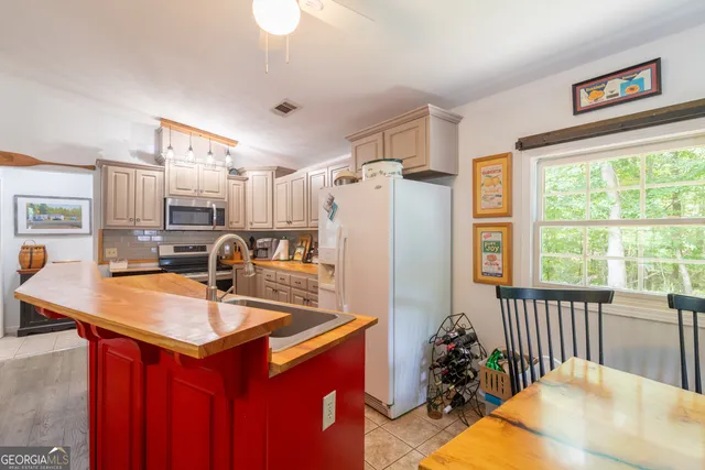 a kitchen with stainless steel appliances granite countertop a refrigerator a sink and a stove