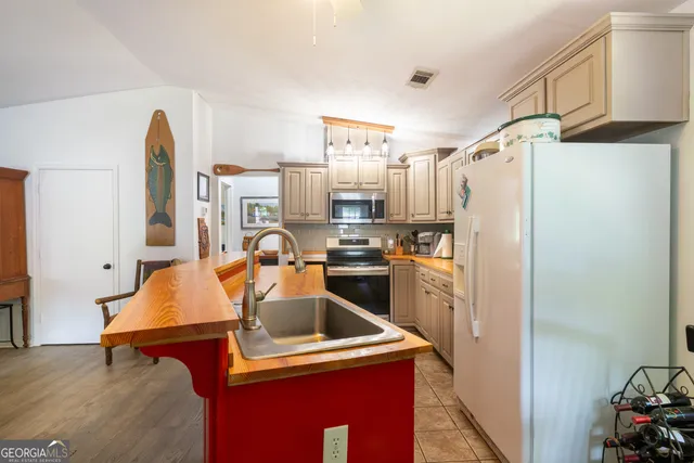 a kitchen with stainless steel appliances granite countertop a refrigerator and a stove